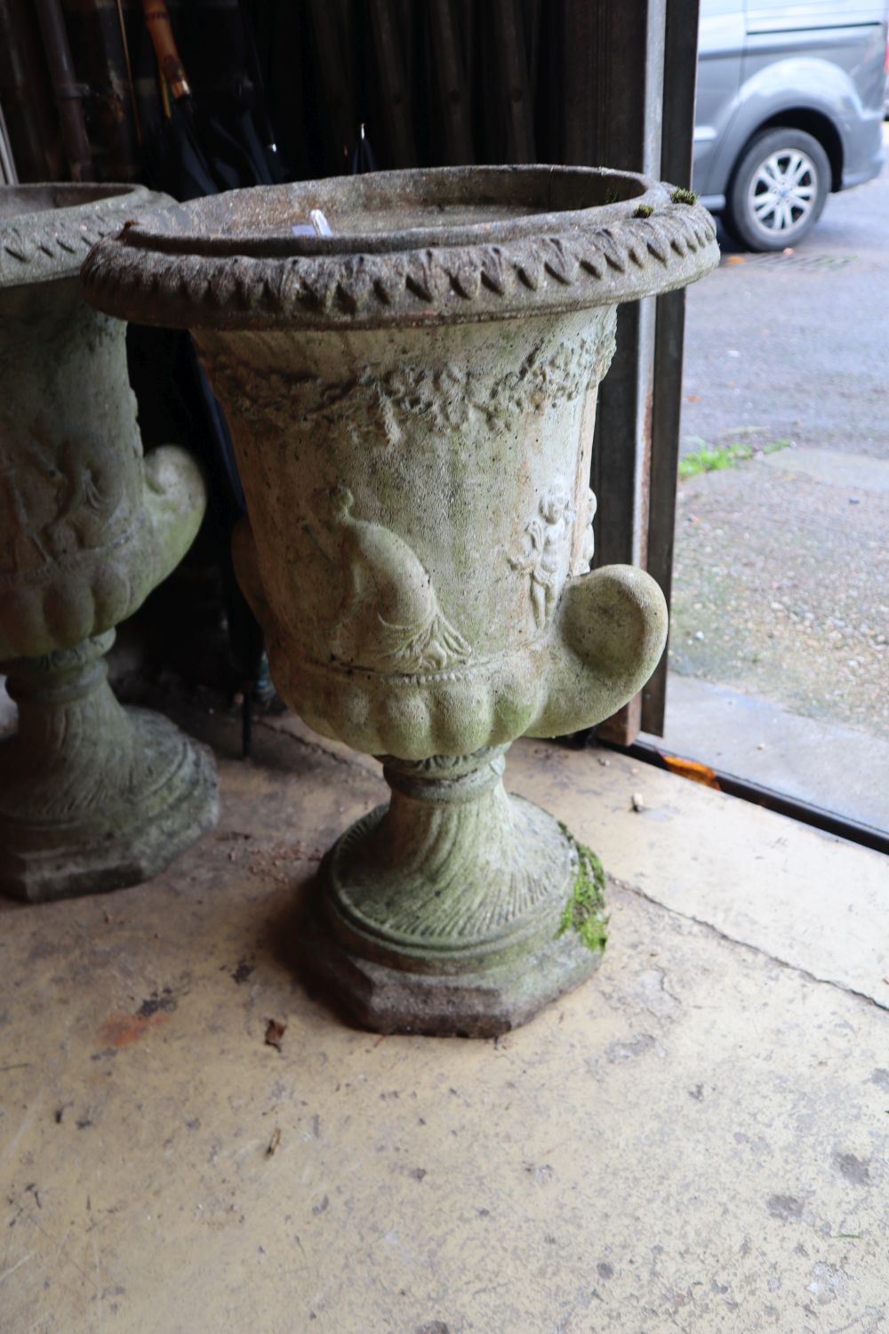 A pair of reconstituted stone garden urns, height 60cm
